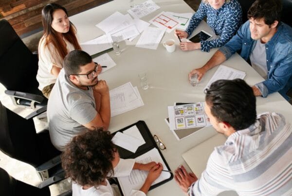 mulher sorrindo segurando tablet com sala ao fundo